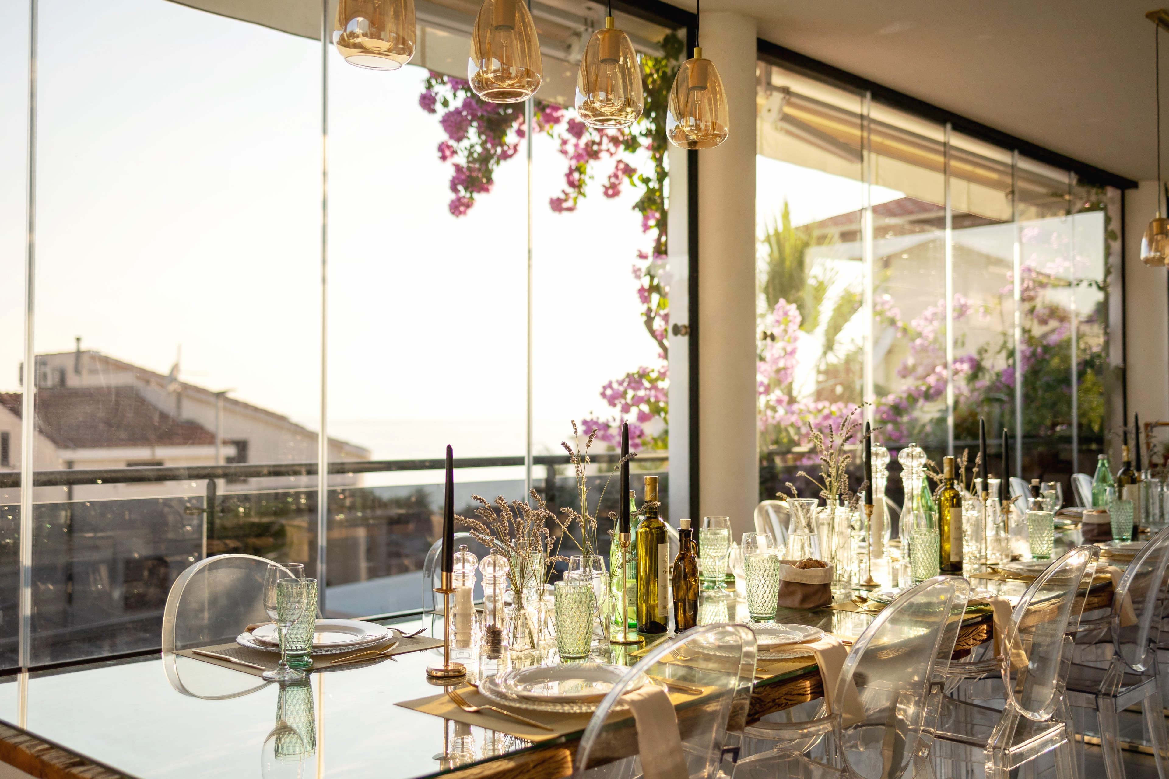 Elegantly set dining table at Villa GG with bougainvillea and sunset views
